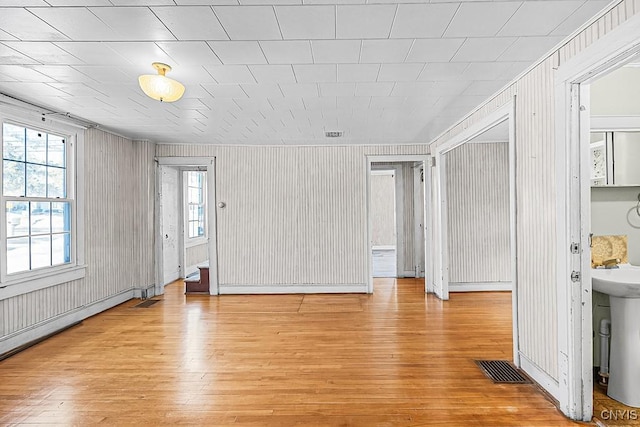 living room featuring light wood-style flooring and visible vents