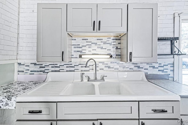 kitchen with decorative backsplash and light countertops