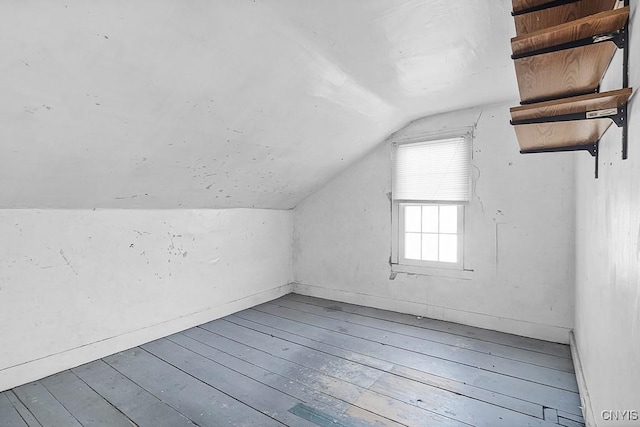 additional living space with wood-type flooring and lofted ceiling