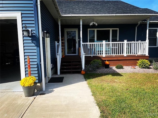 doorway to property with a porch and a shingled roof