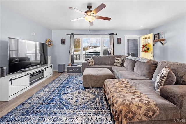 living room with ceiling fan and wood finished floors