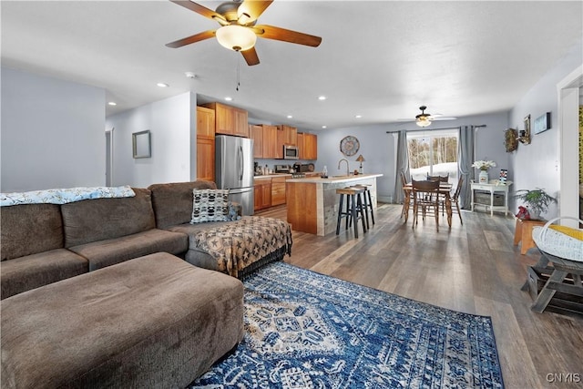 living room with recessed lighting, wood finished floors, and ceiling fan