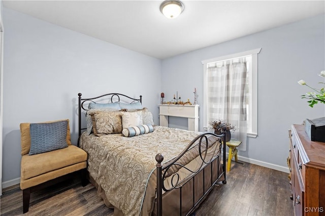 bedroom with baseboards and dark wood-style flooring