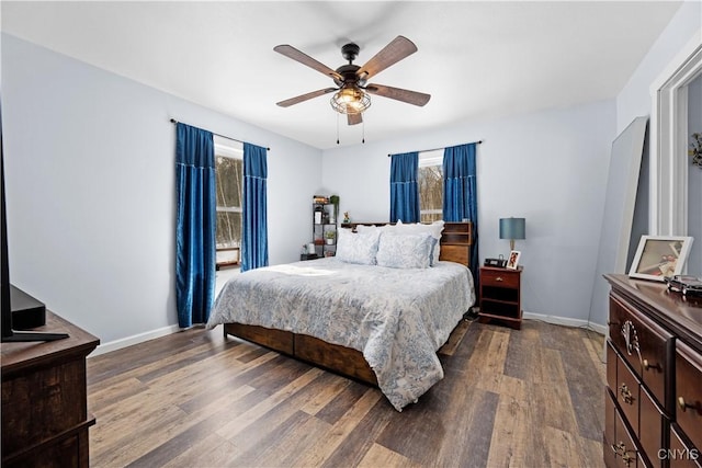 bedroom with ceiling fan, baseboards, and dark wood-style flooring