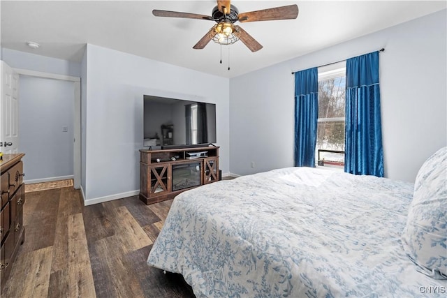 bedroom featuring dark wood finished floors, ceiling fan, and baseboards