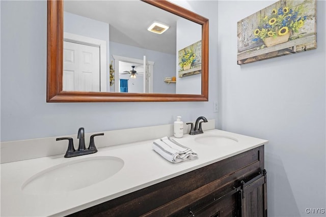 bathroom with a sink, visible vents, ceiling fan, and double vanity