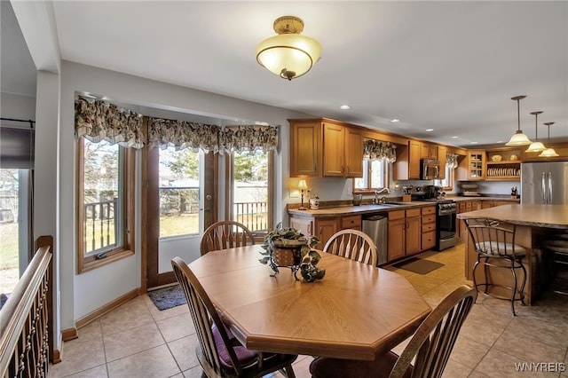 dining area with light tile patterned floors, baseboards, and recessed lighting