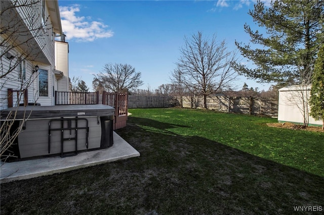 view of yard with a fenced backyard and a hot tub