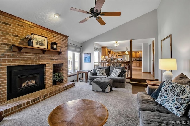 living room featuring carpet, ceiling fan, a fireplace, and high vaulted ceiling