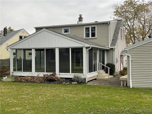 back of house with a patio area, a lawn, and a sunroom