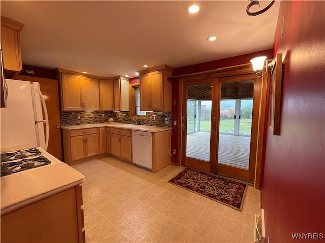 kitchen with white appliances, light floors, recessed lighting, decorative backsplash, and light countertops