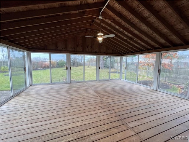 unfurnished sunroom featuring a ceiling fan and vaulted ceiling