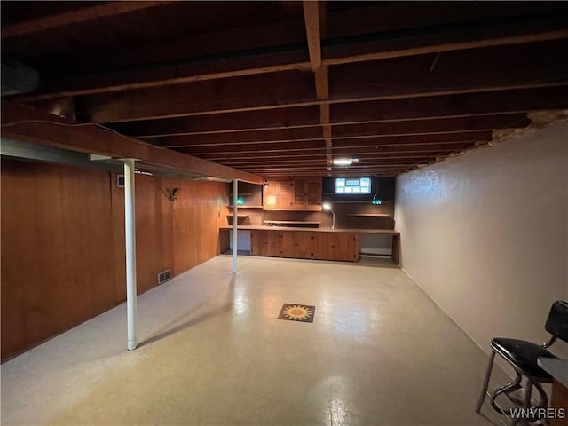 below grade area featuring tile patterned floors and a sink