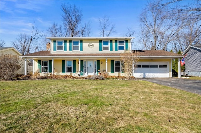 view of front of house with aphalt driveway, an attached garage, covered porch, and a front yard