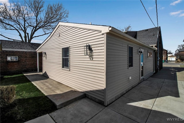 view of side of home featuring a patio area