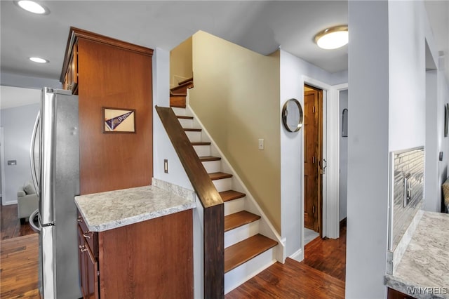 stairs with recessed lighting, wood finished floors, and baseboards