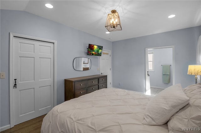 bedroom with recessed lighting, wood finished floors, ensuite bathroom, and a chandelier