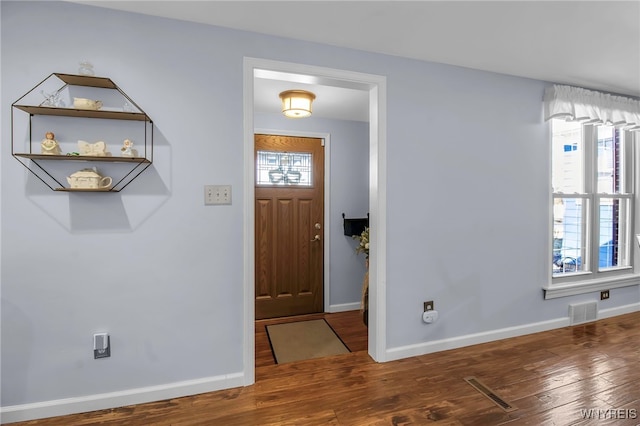 entryway featuring hardwood / wood-style flooring, baseboards, and visible vents