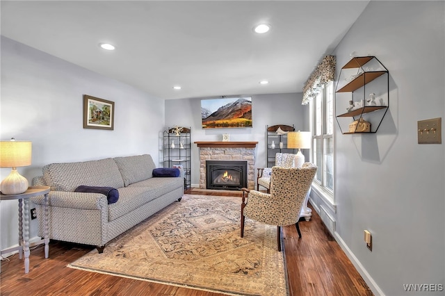 living room featuring a fireplace, recessed lighting, wood finished floors, and baseboards