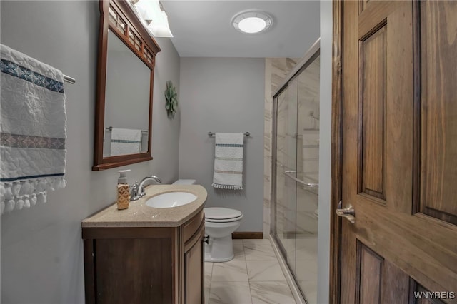 full bathroom featuring vanity, baseboards, a stall shower, toilet, and marble finish floor