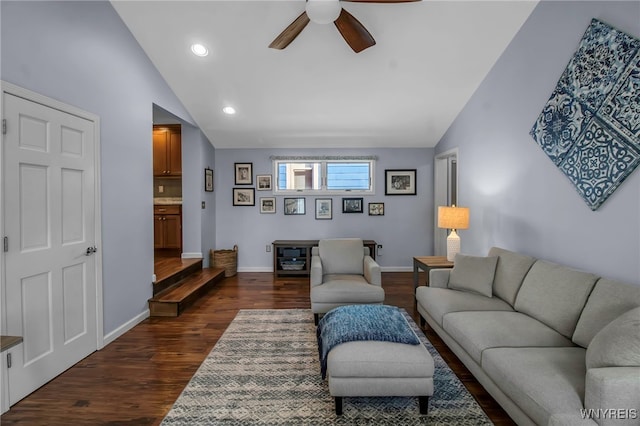 living area with baseboards, a ceiling fan, lofted ceiling, and dark wood-style flooring