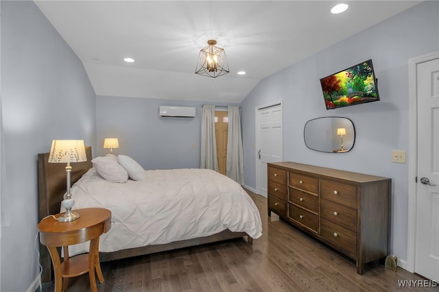 bedroom featuring vaulted ceiling, recessed lighting, wood finished floors, and a wall mounted air conditioner