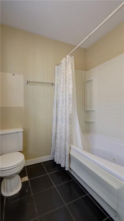 bathroom with baseboards, toilet, shower / tub combo with curtain, and tile patterned flooring