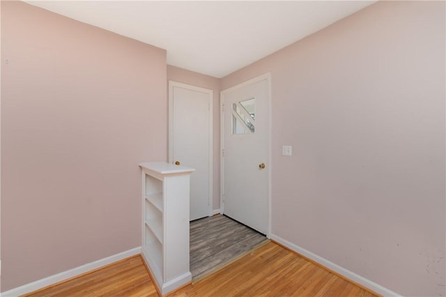 entrance foyer with light wood-type flooring and baseboards