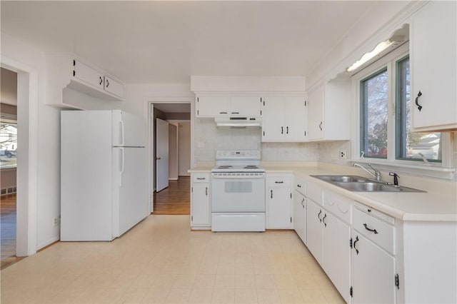 kitchen featuring under cabinet range hood, light countertops, white appliances, white cabinetry, and a sink