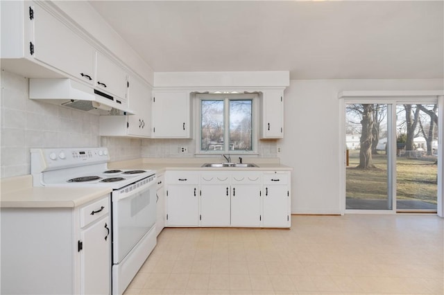 kitchen featuring a sink, electric range, under cabinet range hood, and light countertops