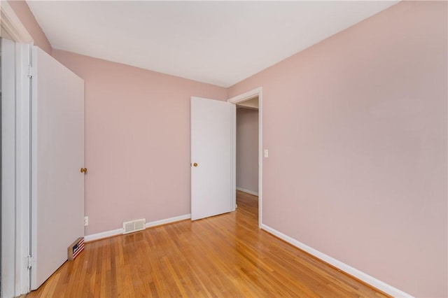 empty room with visible vents, baseboards, and light wood-style flooring