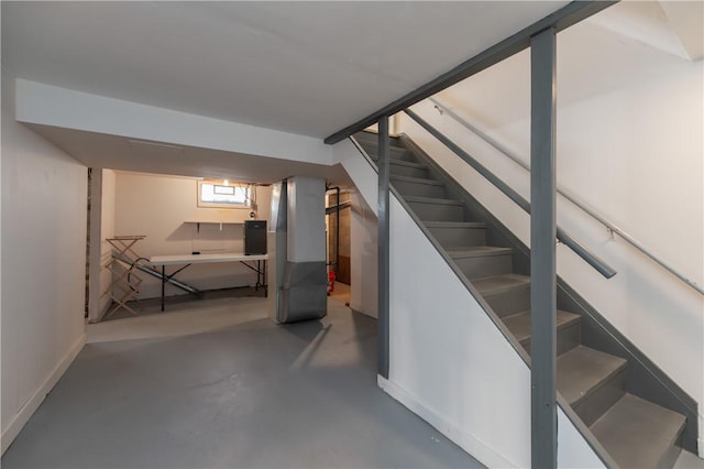 basement with electric panel and stairway