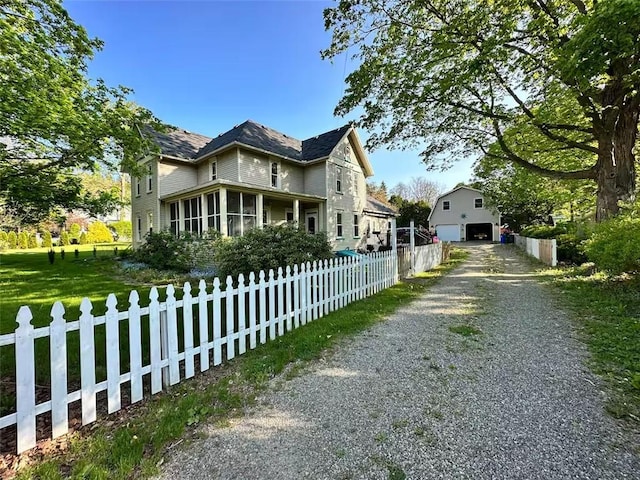 view of front facade featuring a fenced front yard and an outdoor structure