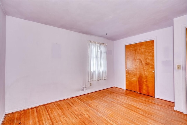 unfurnished bedroom with light wood-type flooring