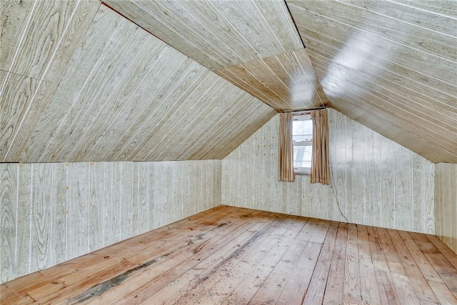 additional living space with hardwood / wood-style flooring, wood ceiling, and vaulted ceiling