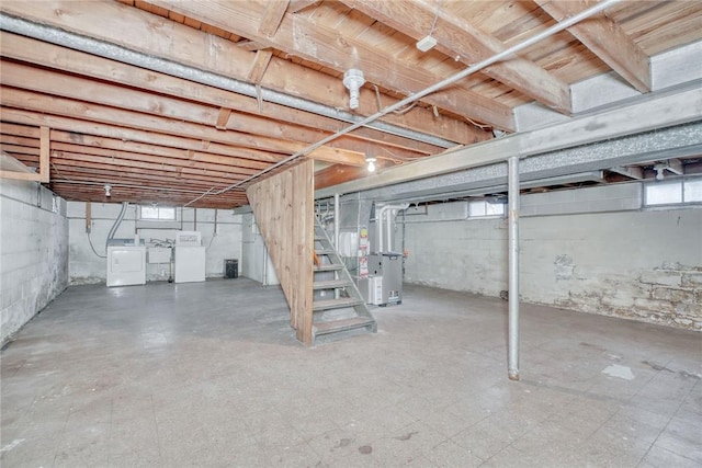 basement with washer and clothes dryer and heating unit