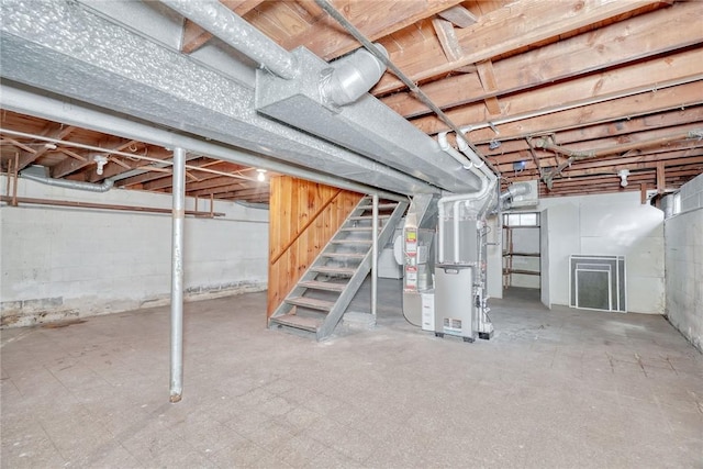 unfinished basement with tile patterned floors and stairs