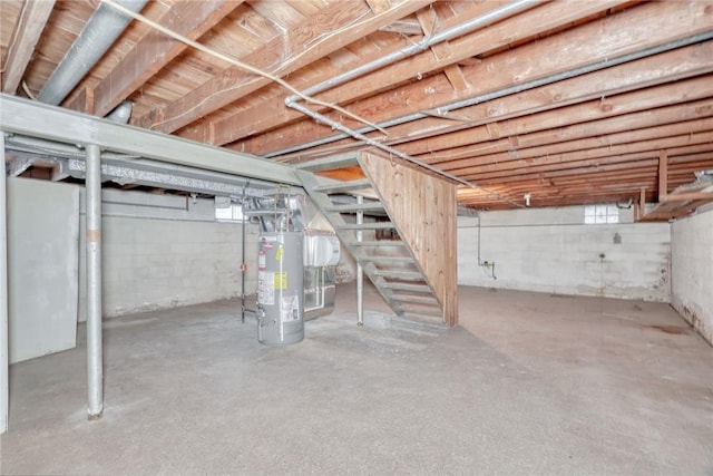 basement featuring stairs and gas water heater