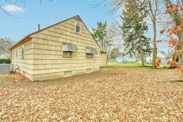 view of property exterior featuring cooling unit and crawl space