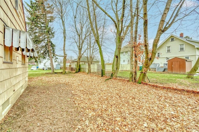 view of yard featuring fence and a residential view