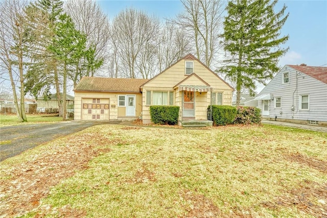 view of front of property with driveway, an attached garage, and a front yard