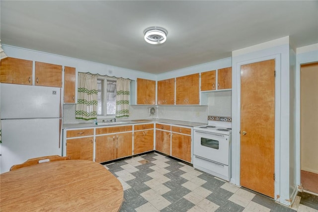 kitchen with white appliances, a sink, light countertops, tile patterned floors, and brown cabinets