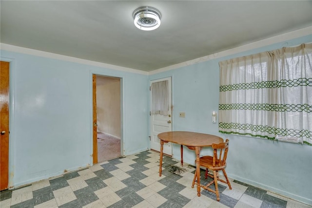 dining area featuring tile patterned floors and baseboards