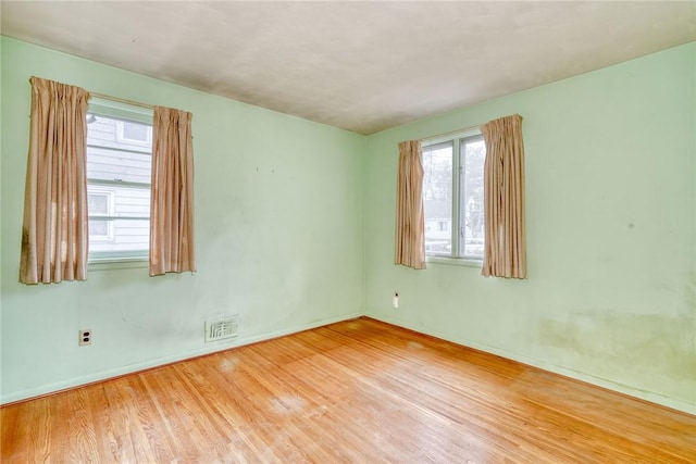 spare room with visible vents and wood finished floors