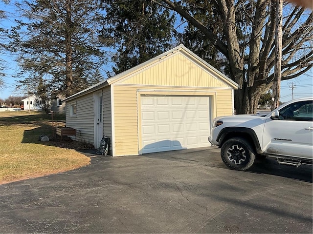 detached garage featuring driveway