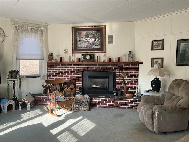 living room featuring visible vents, carpet floors, and a brick fireplace