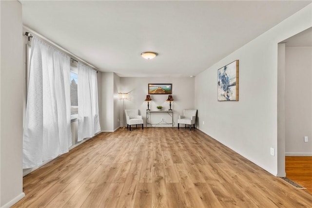 unfurnished room with visible vents and light wood-style flooring