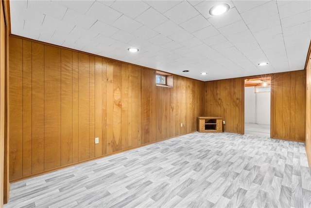 finished below grade area featuring recessed lighting, wood finished floors, and wood walls