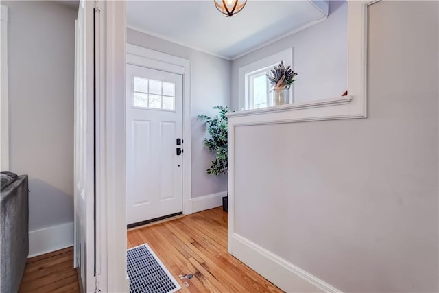 entrance foyer with visible vents, baseboards, and light wood-style flooring