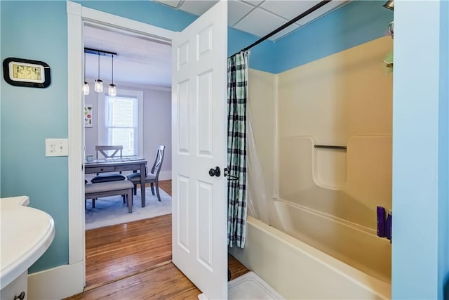 full bath with shower / bathtub combination with curtain and wood finished floors